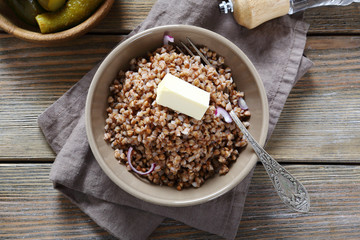Buckwheat with piece of butter on board