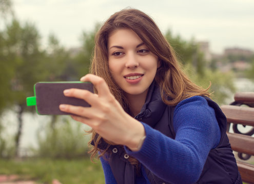 Portrait of a beautiful young woman with a mobile phone .