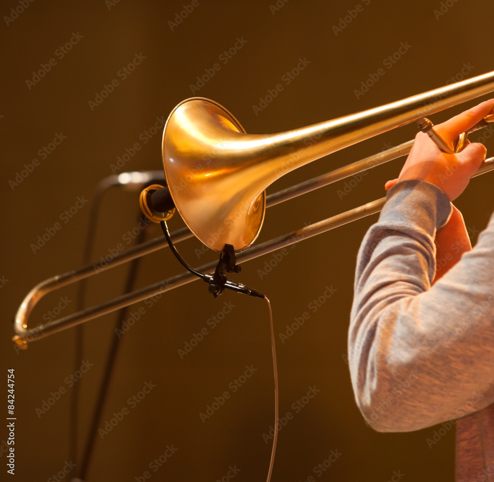 Poster fragment of the trombone in the hands of the musician