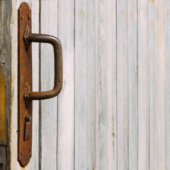 Rusted handle and old wooden wall. Texture. Background.