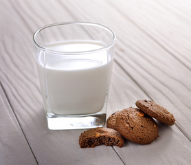 cookies and milk on a white wooden background