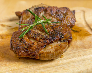 Fried duck breast with rosemary on board