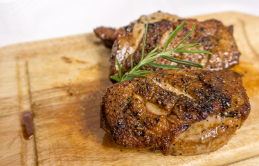 Fried duck breast with rosemary on board