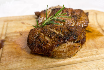 Fried duck breast with rosemary on board