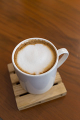 capucino coffee on wood background