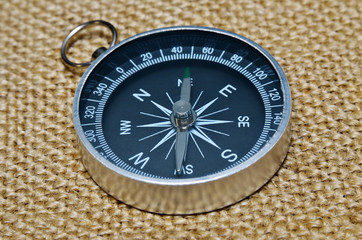 Fototapeta na wymiar Mariner's compass on a rough cloth closeup