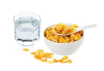 cornflakes in white bowl and drinking water on white