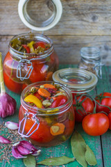 Open glass jar of tasty canned tomatoes