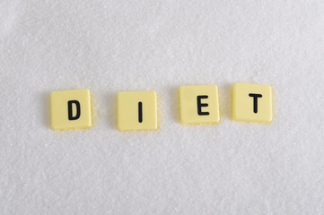 diet block letters in crossword over sugar pile grainy texture