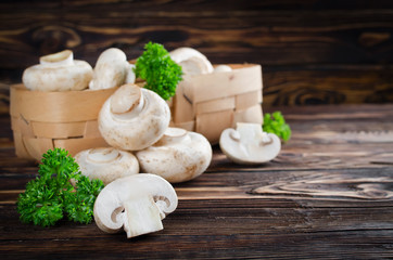 Сhampignons with parsley in a basket