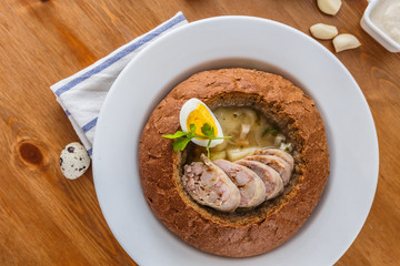 Traditional polish zurek with sausage, egg in bread