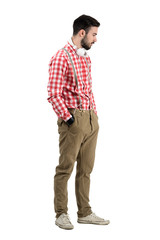 Fototapeta premium Hipster dj with earphones around his neck looking down