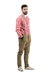 Naklejka premium Young hipster dj posing with headphones isolated
