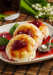 Homemade cottage cheese pancakes with strawberry jam, selective