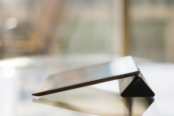 digital tablet on a glass table