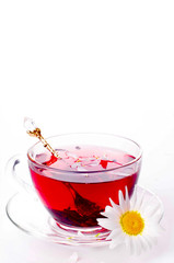 Cup of tea with teabag over white