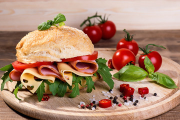 Italian ciabatta with ham and cheese on the wooden background