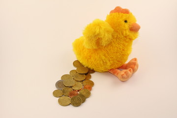 Gold (money) laying plush hen doll on a white background