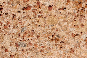 Pebble-embedded stone texture as a background