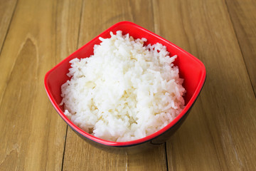 ripe rice in bowl on wooden board