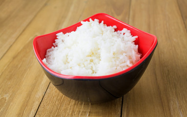 ripe rice in bowl on wooden board