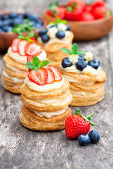 homemade puff pastry stuffed with cream and berries on the rusti