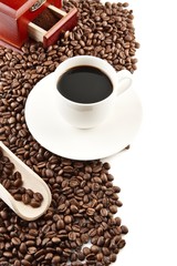 Cup of coffee with saucer and mill background