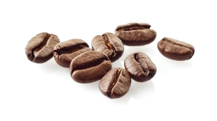 Scattered coffee beans on white