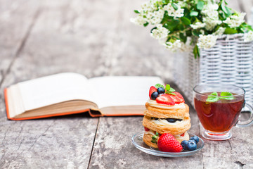 puff pastry with berries old book and beautiful bouquet of white © lena_zajchikova