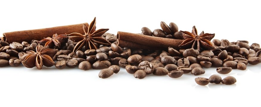 Scattered coffee beans in line on white