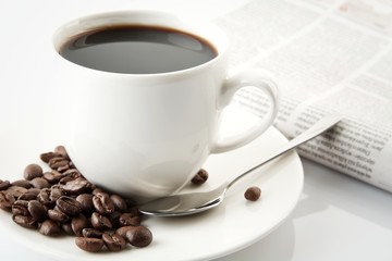 Cup of coffee with newspaper at breakfast