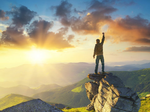 Silhouette of a champion on mountain peak. Active life concept