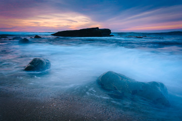 Waves and rocks in the Pacific Ocean at sunset, seen at Shell Be