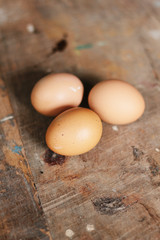 Chicken eggs on wood background , selective focus