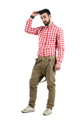 Fototapeta premium Cool hipster with flirt look putting sunglasses on his head