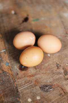 Chicken eggs on wood background , selective focus
