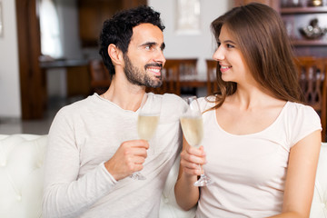 Young couple celebrating with champagne glasses