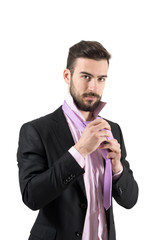 Young business tying necktie isolated