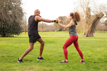 young couple boxing in the park