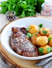 Medium rare grilled Beef steak with roasted potato 