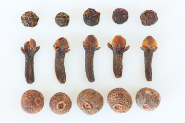 Isolated cloves, allspice and black peppers still life