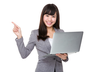 Young businesswoman hold with laptop and finger pointing upwards