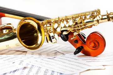Obraz premium Cello tuning pegs and shiny golden alto saxophone