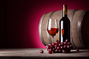 Glass of red wine with bottle and grapes - 84273398
