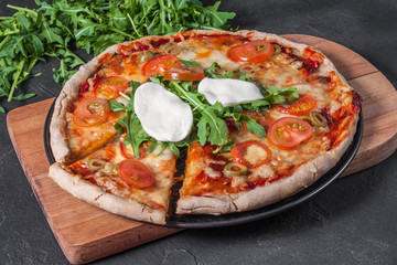 Vegetarian pizza with mozzarella and arugula.