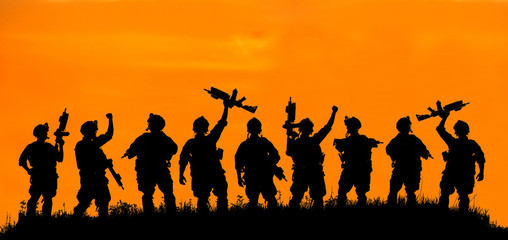 Fototapeta na wymiar Silhouette of military team soldiers or officers with weapons