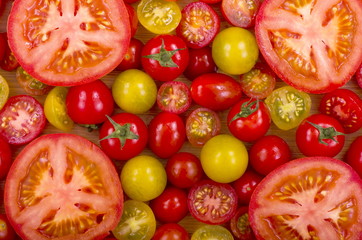 A selection of fresh tomatoes, some sliced open.