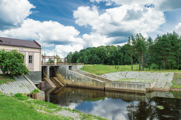 Fototapeta na wymiar Village hidroelectric dam with forest and river