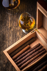 humidor with quality cigar and cognac