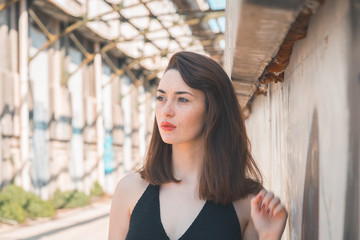 Fototapeta premium Beautiful brunette posing in an industrial context
